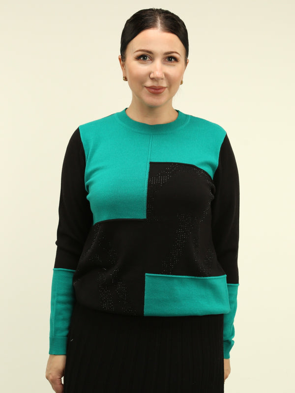 Woman wearing a black and teal color block sweater